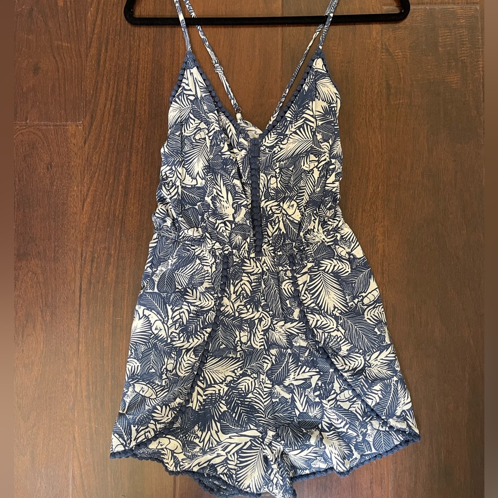 Never worn romper blue and white pattern. Adjustable straps